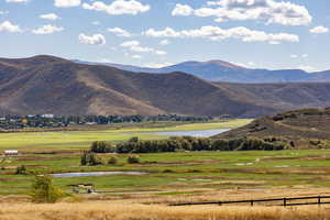 View of mountain backdrop featuring a large body of water