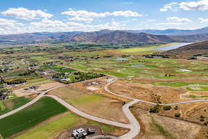Aerial view of sparsely populated area featuring a water and mountain view
