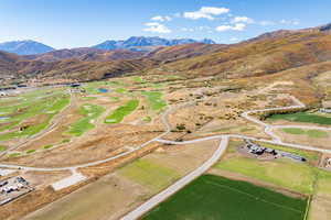 Aerial view of property and surrounding area with a mountainous background and rural landscape