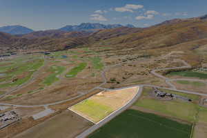 Aerial view of property's location with a mountain backdrop and rural landscape