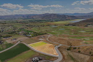 Aerial overview of property's location featuring property parcel outlined, rural landscape, and a water and mountain view