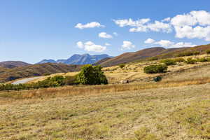 View of mountain backdrop with rural landscape
