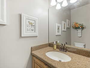 Half bath featuring vanity and toilet