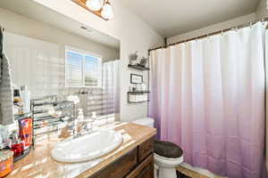 Bathroom featuring vanity and a shower with shower curtain