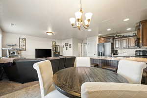Dining space featuring recessed lighting and a chandelier