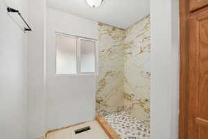 First floor guest bathroom featuring a walk in shower.