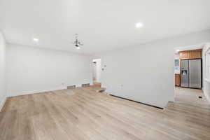 First floor living room and entry to the kitchen.