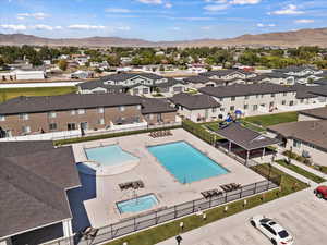 Aerial view of residential area with a pool area and a mountain backdrop