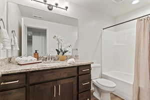Full bath featuring vanity, shower / bath combination with curtain, wood finished floors, and recessed lighting
