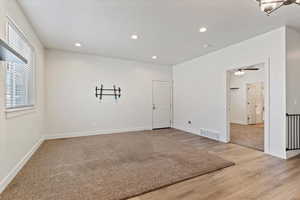 Unfurnished room with recessed lighting and light wood-type flooring