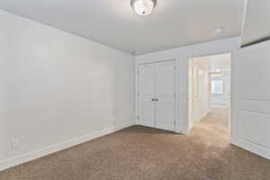 Unfurnished bedroom with carpet floors and a closet
