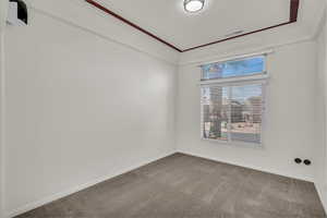 Unfurnished room with carpet flooring and baseboards