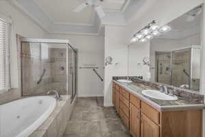 Full bath featuring a jetted tub, double vanity, and a shower stall