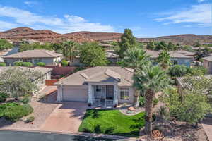 View of front of house featuring concrete driveway, a mountain view, a residential view, a garage, and stucco siding