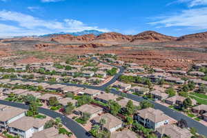 Aerial view of property's location with a mountainous background and nearby suburban area