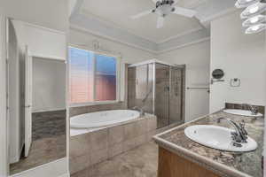 Full bathroom with a shower stall, a bath, double vanity, and ceiling fan