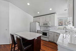 Beautiful kitchen with white cabinets and appliances.