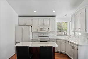 Beautiful kitchen with white cabinets and appliances.