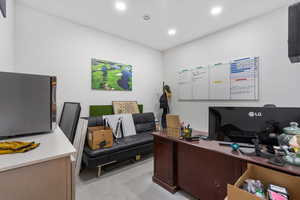 Office area featuring concrete flooring and recessed lighting