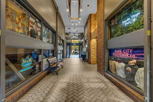 Community lobby featuring a high ceiling and brick wall