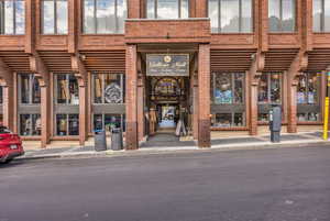 Property entrance featuring brick siding