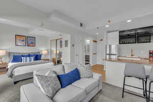 Bedroom featuring recessed lighting, freestanding refrigerator, a closet, and light wood-style floors