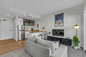 Living area with recessed lighting and light carpet