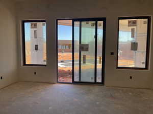 Unfurnished room with unfinished concrete floors
