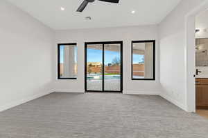 Empty room with light colored carpet, a ceiling fan, and recessed lighting