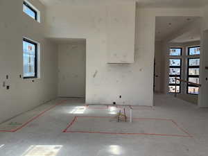 Kitchen featuring white cabinets and a towering ceiling