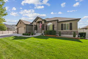 Ranch-style home with stucco siding, concrete driveway, a garage, and roof with shingles