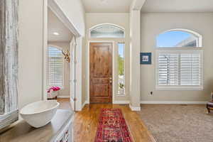 Foyer entrance with plenty of natural light and light wood finished floors