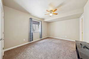 Unfurnished bedroom with light carpet and a ceiling fan