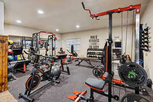 Exercise room featuring rubber floors and recessed lighting