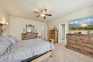 Bedroom featuring light carpet and a ceiling fan