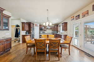 Dining space featuring dark wood-style floors and recessed lighting