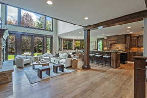 Living room with recessed lighting and light wood-type flooring