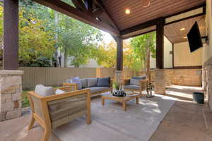 Fenced backyard featuring a patio area and an outdoor hangout area