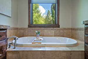 Full bathroom featuring a bath