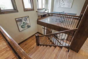 Stairway featuring hardwood / wood-style flooring and baseboards