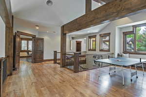 Game room featuring light wood finished floors, recessed lighting, and beamed ceiling