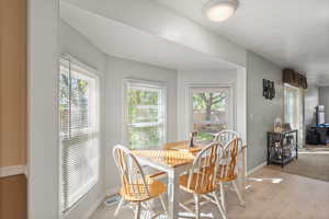 Breakfast nook with healthy amount of natural light and light wood finished floors