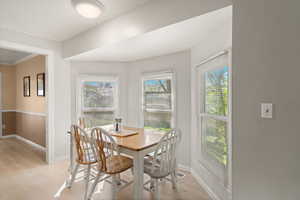 Breakfast nook featuring light wood finished floors and ornamental molding