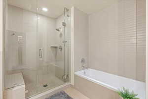 Full bathroom with a garden tub, a stall shower, tile patterned floors, and recessed lighting