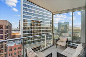 Balcony with a view of city and an outdoor living space