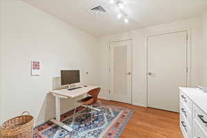 Office area featuring light wood-type flooring and baseboards