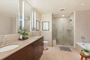 Full bath featuring a stall shower, a bath, tile walls, double vanity, and light tile patterned floors
