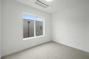 Carpeted spare room with baseboards and cooling unit