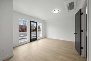 Spare room with light wood-type flooring and baseboards