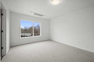 Unfurnished room with carpet flooring and baseboards